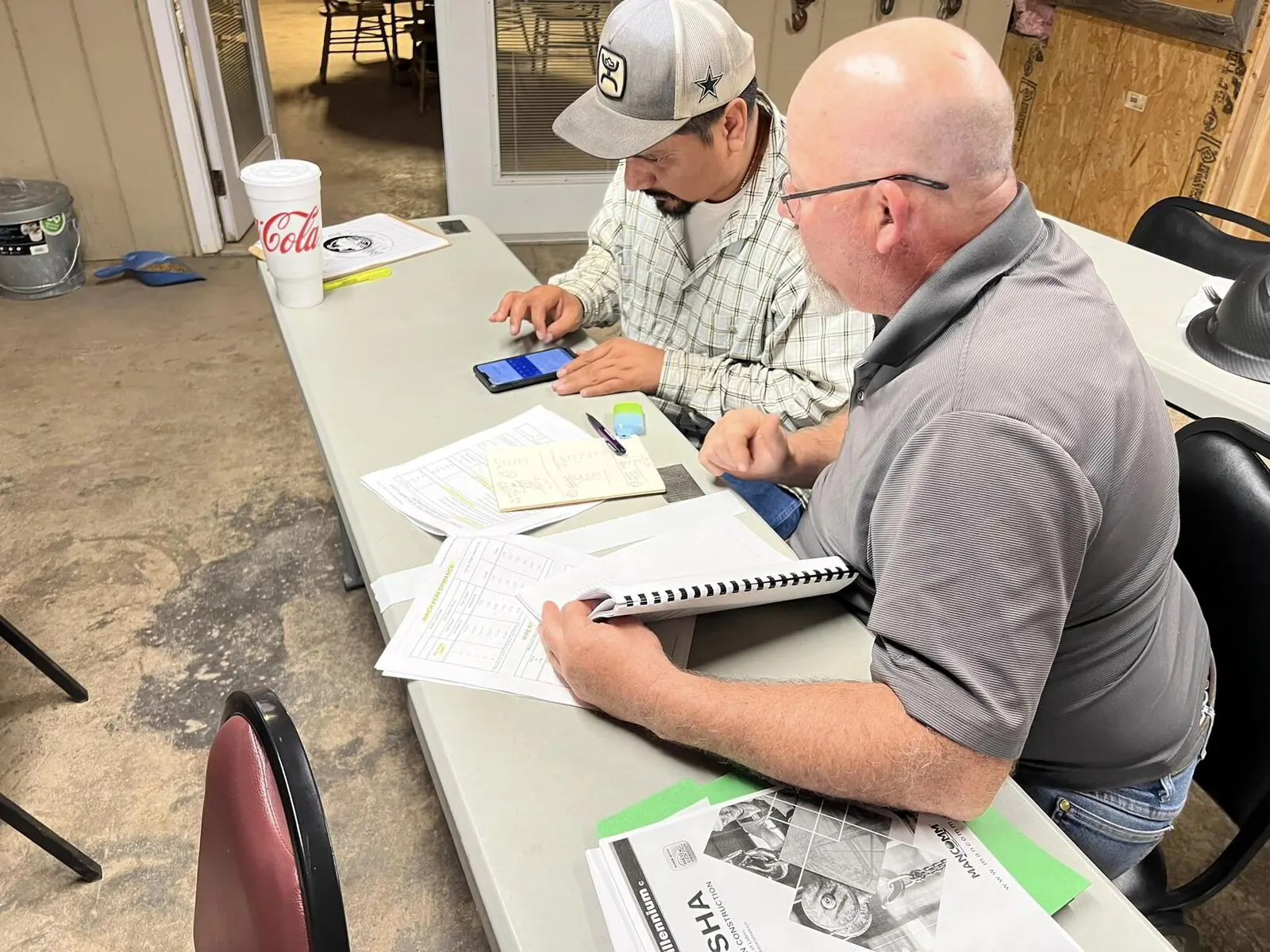 Instructor reviewing a crane load chart with a student