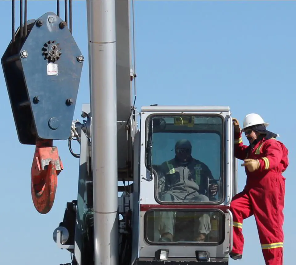 Crane operator in the cab working with a ground crew at the Miller Crane Works training yard